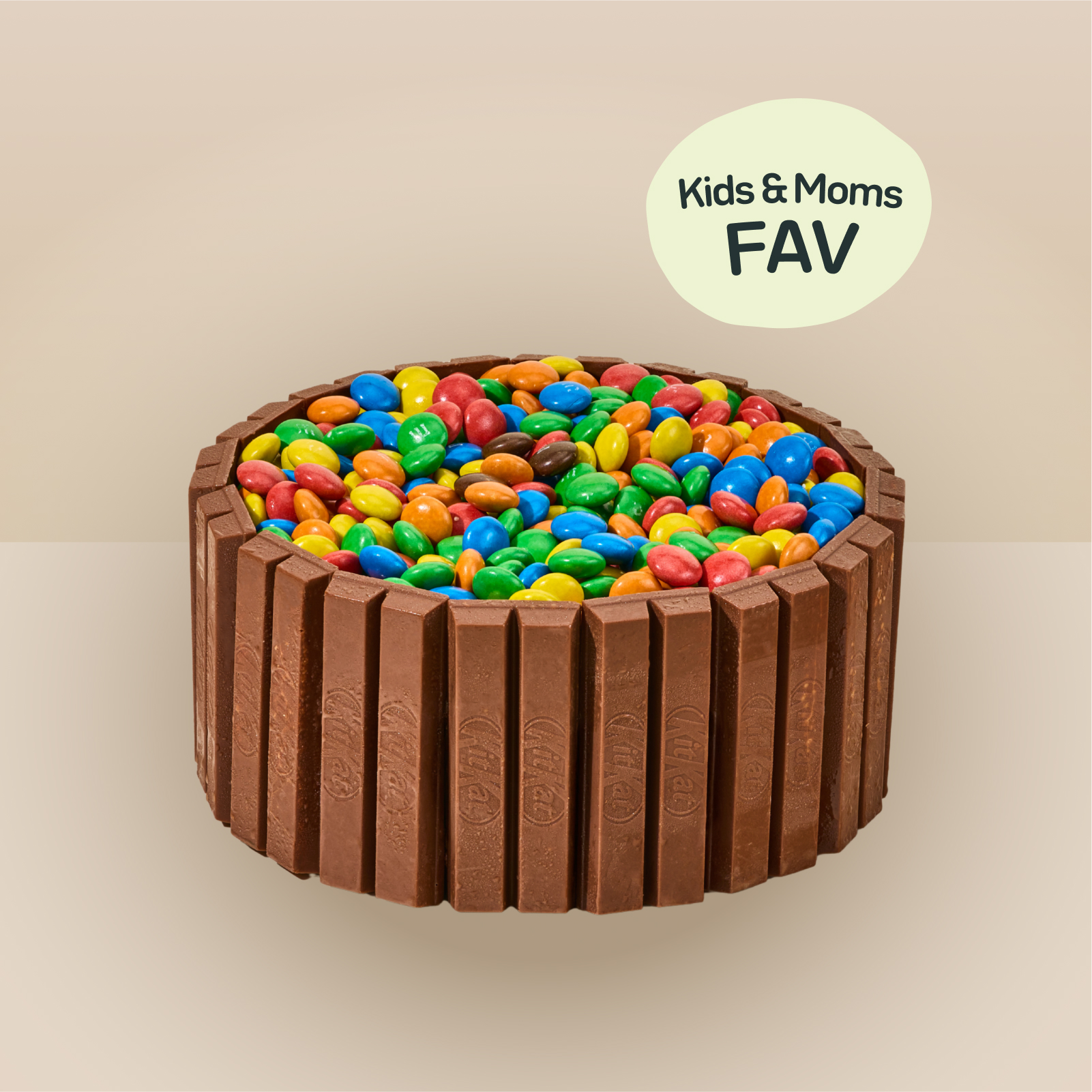 A Udders ice cream cake wrapped in KitKat fingers and topped with a colourful pile of M&Ms, served in Singapore